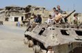 Children of war on burnt tank