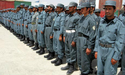 Afghan police officers who were trained by the British soldiersmstand during a graduation ceremony in Helmand, Afghanistan, 4 August 2010
