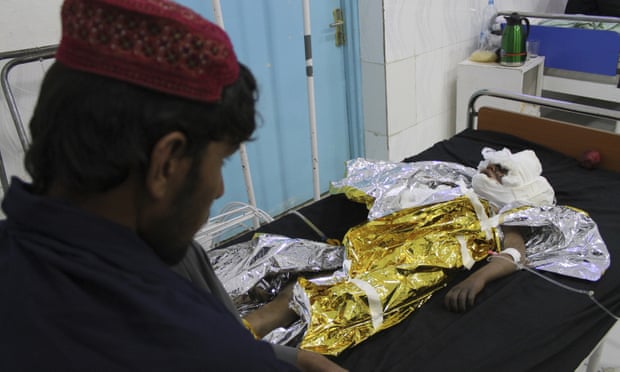 : An injured boy receives treatment at a hospital after an airstrike in Helmand province killed 30 civilians
