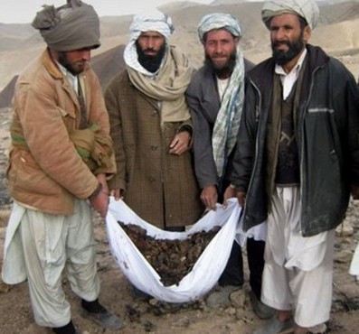 Afghans carry body parts of the victims