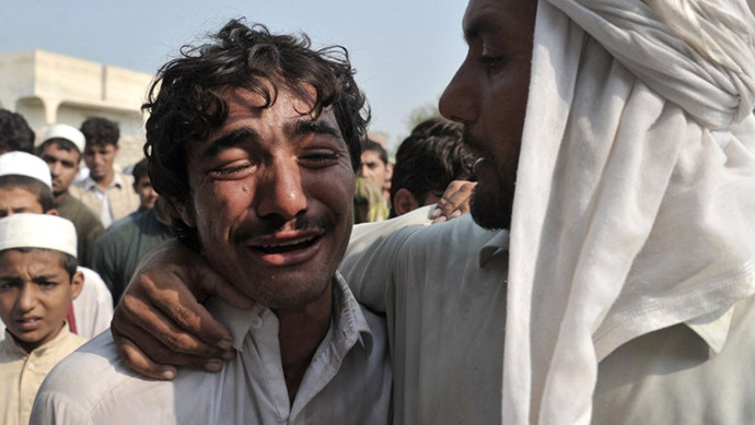 An Afghan man weeps over the death of his brother, allegedly killed in a NATO air strike, on the outskirts of Jalalabad in Nangarhar province