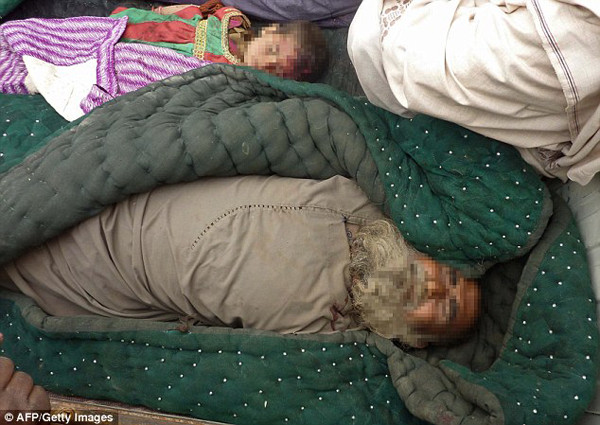 The bodies of an elderly Afghan man and a child killed in the Alkozai village of Panjwayi district are shown wrapped in blankets