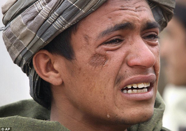 An Afghan youth mourns for his relatives, who were allegedly killed by the U.S. service member