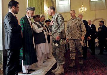 Hamid Karzai (second from l.) receives condolences from then-US Army Gen. David Petraeus (c.) at a funeral for his late half brother Ahmad Wali Karzai