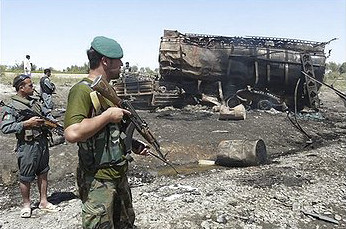 Police officer next to a tanker after bombardment