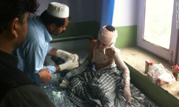 An injured student gets treatment after a suicide bomber blew himself up outside a school