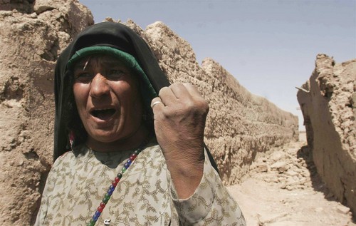 An Afghan woman shouts anti U.S. slogans