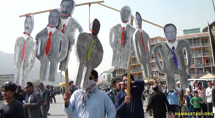 Protestors of the Solidarity Party of Afghanistan hold dummies of the high-ranking Soviet puppet regime officials