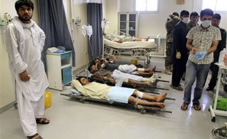Afghan victims of a suicide attack are seen on stretchers at a hospital in Kandahar