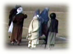 Taliban armed guards push her to the center of soccer ground for execution.